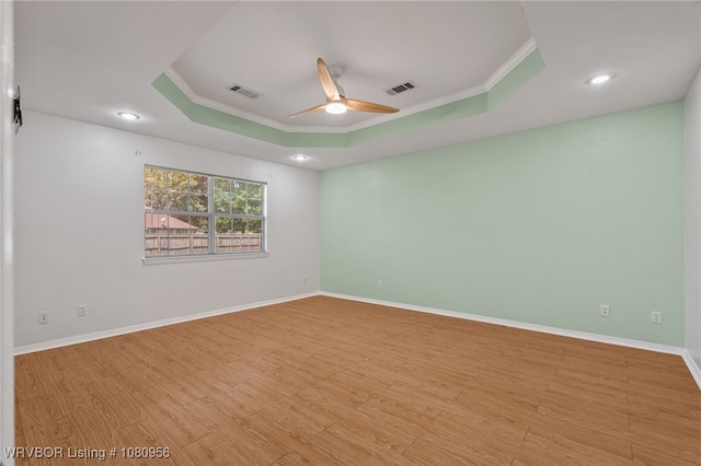 813 Melba Denton Ln, Sallisaw, OK 74955 - unfurnished room with a raised ceiling, a ceiling fan, crown molding, wood finished floors, and baseboards