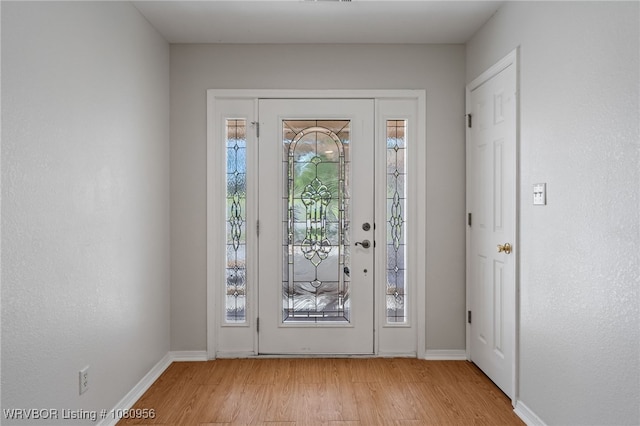 813 Melba Denton Ln, Sallisaw, OK 74955 - foyer featuring light wood-style flooring and baseboards