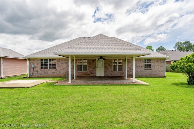 813 Melba Denton Ln, Sallisaw, OK 74955 - rear view of house with a ceiling fan, a lawn, a patio area, a shingled roof, and brick siding
