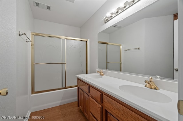 813 Melba Denton Ln, Sallisaw, OK 74955 - full bathroom with wood finished floors, double vanity, and enclosed tub / shower combo
