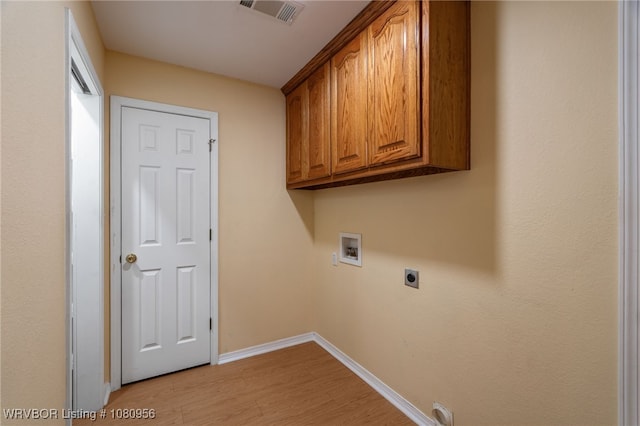 813 Melba Denton Ln, Sallisaw, OK 74955 - washroom featuring hookup for a washing machine, hookup for an electric dryer, baseboards, light wood-style flooring, and cabinet space