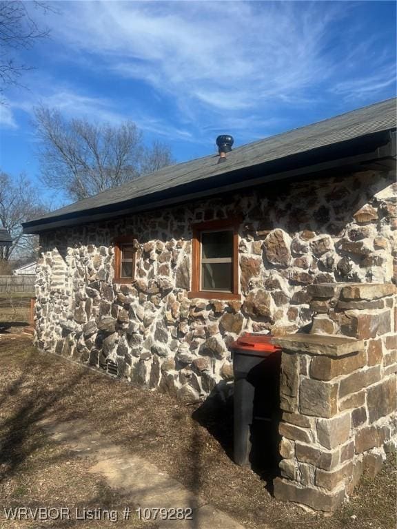 view of property exterior with stone siding