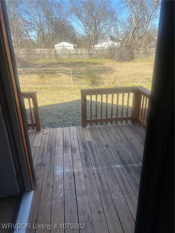 deck with a lawn and fence