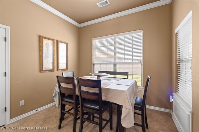 dining room with baseboards, ornamental molding, tile patterned floors, and visible vents