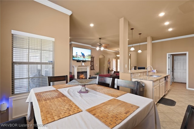dining space with a glass covered fireplace, recessed lighting, ceiling fan, and crown molding