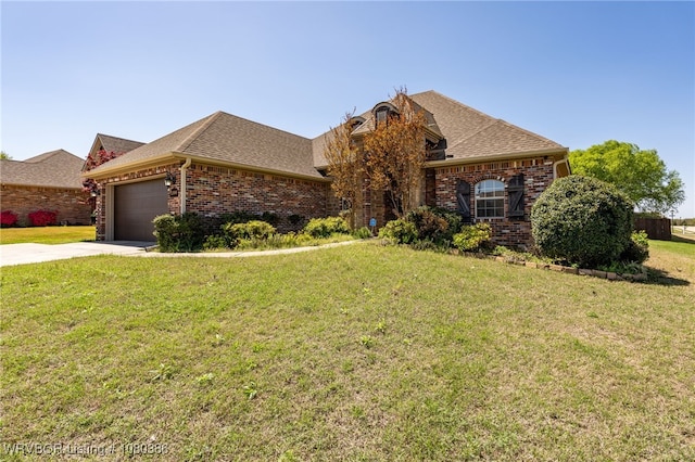 ranch-style house with a front lawn, driveway, brick siding, an attached garage, and a shingled roof