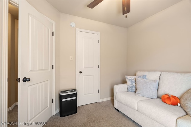 living room with carpet flooring, baseboards, and ceiling fan