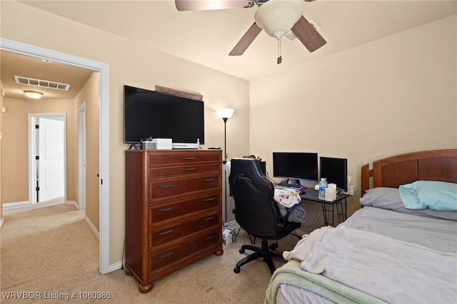 bedroom with ceiling fan, light carpet, visible vents, and baseboards