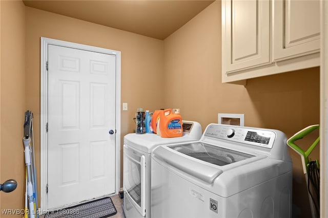 laundry room with washing machine and dryer and cabinet space