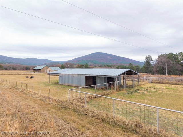 view of outdoor structure with a mountain view and a rural view