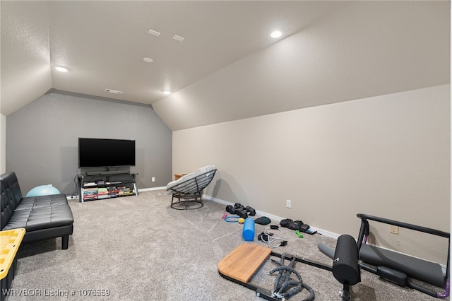 workout room with carpet floors and vaulted ceiling