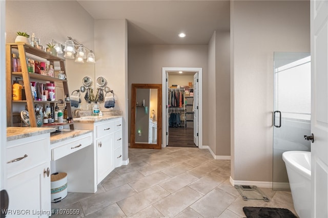 bathroom with vanity, tile patterned floors, and independent shower and bath