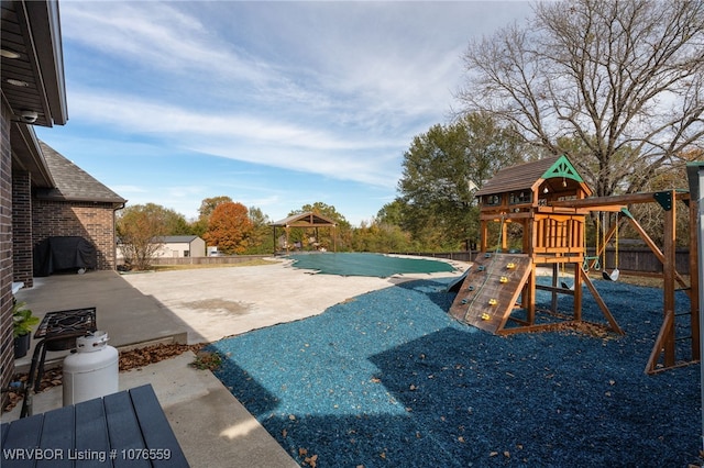 exterior space with a playground and a patio area