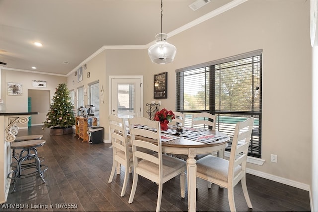 dining room with ornamental molding and dark wood-type flooring