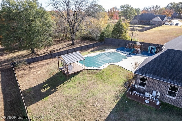 view of swimming pool with a lawn and a wooden deck