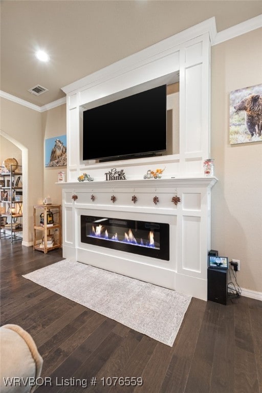 living room featuring dark hardwood / wood-style flooring and ornamental molding