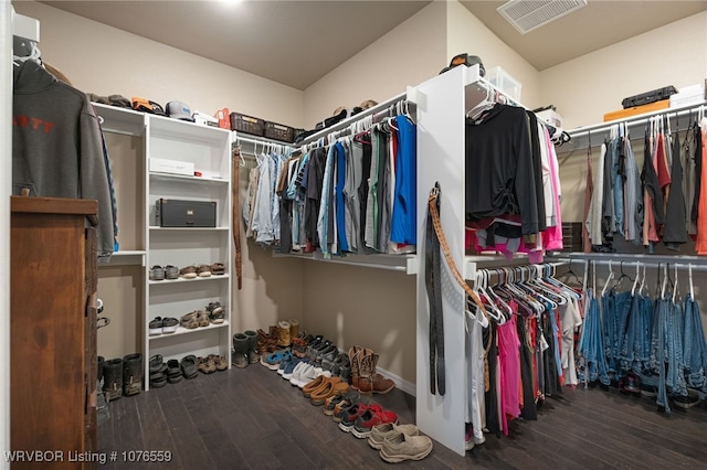 walk in closet with dark hardwood / wood-style flooring