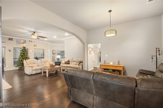 living room with dark hardwood / wood-style flooring, ceiling fan, and crown molding