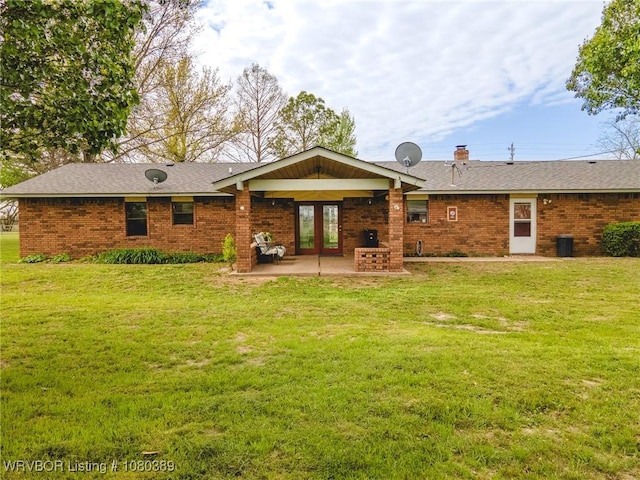 3745 E 420th Rd, Adair, OK 74330 - rear view of house with brick siding, a patio area, a lawn, and a chimney