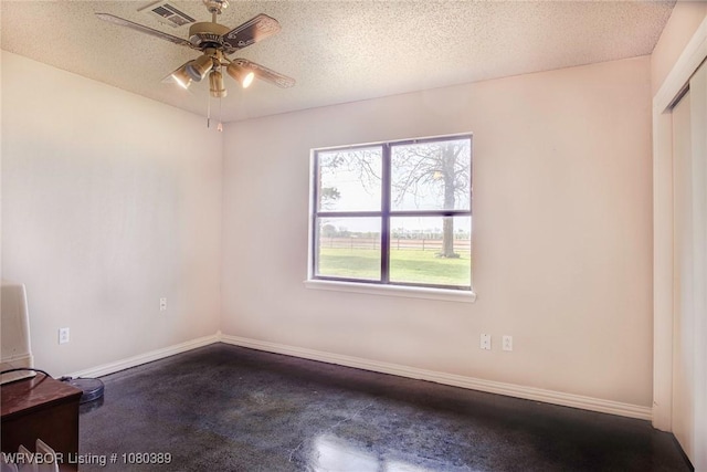 3745 E 420th Rd, Adair, OK 74330 - unfurnished room featuring baseboards, a ceiling fan, visible vents, and a textured ceiling