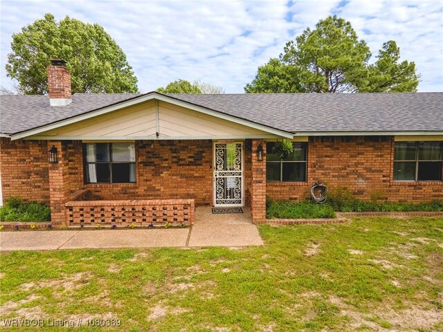 3745 E 420th Rd, Adair, OK 74330 - view of front of home with brick siding, a chimney, a front yard, and a shingled roof