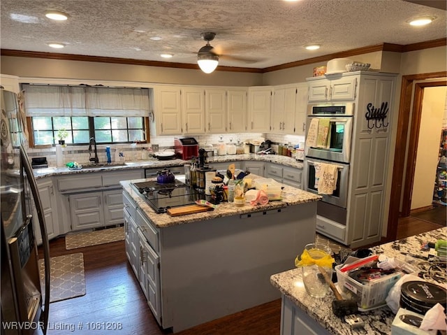 2904 Cedar Valley Dr, Greenwood, AR 72936 - kitchen featuring gray cabinetry, a kitchen island, double oven, crown molding, and a sink