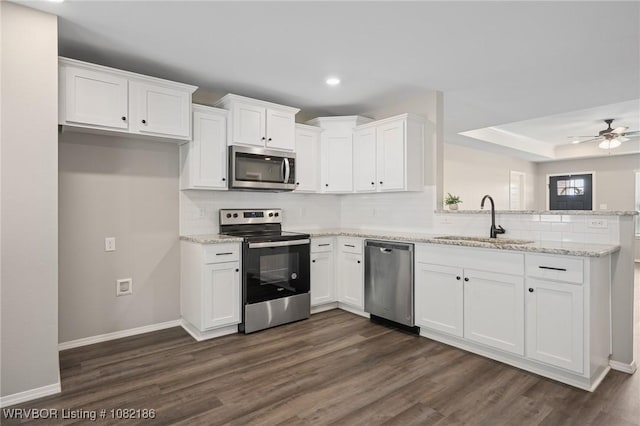 2325 Amy Ln, Van Buren, AR 72956 - kitchen featuring stainless steel appliances, a peninsula, dark wood-style flooring, backsplash, and white cabinets