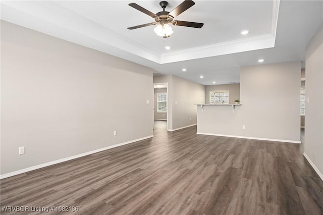 2325 Amy Ln, Van Buren, AR 72956 - unfurnished living room featuring a tray ceiling, recessed lighting, ceiling fan, ornamental molding, and dark wood-style floors
