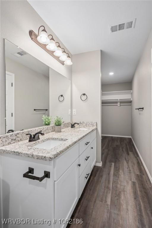 2325 Amy Ln, Van Buren, AR 72956 - bathroom featuring double vanity, wood finished floors, and a spacious closet