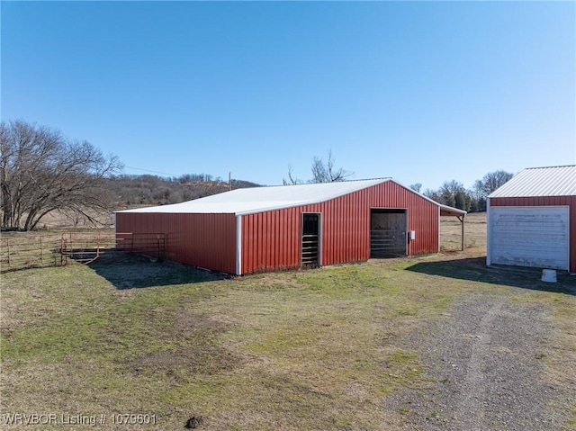 view of pole building featuring a lawn and dirt driveway