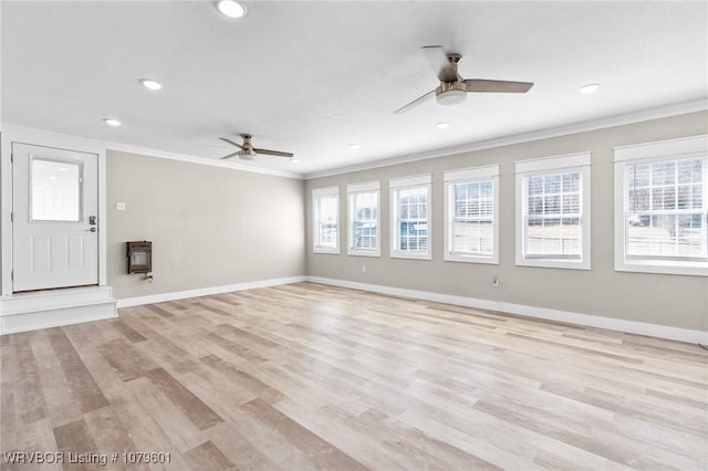 unfurnished living room featuring light wood-style flooring, baseboards, crown molding, and ceiling fan