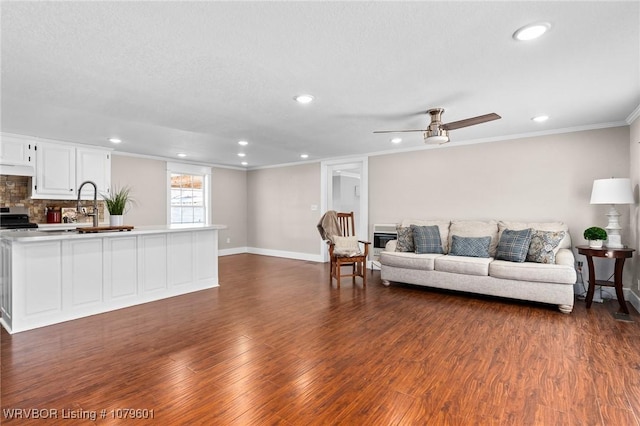 living area featuring dark wood-style floors, recessed lighting, crown molding, baseboards, and ceiling fan