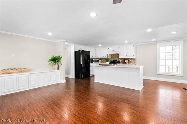 kitchen with backsplash, light countertops, ornamental molding, stainless steel appliances, and dark wood-style flooring