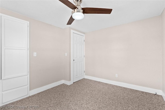 unfurnished bedroom featuring a ceiling fan, carpet, and baseboards