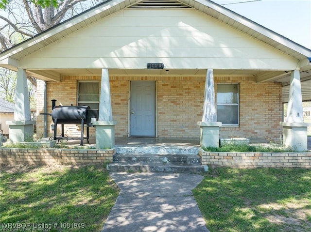1120 Second St, Charleston, AR 72933 - bungalow-style home featuring a porch and brick siding