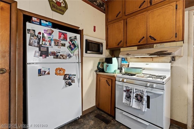 1120 Second St, Charleston, AR 72933 - kitchen featuring white appliances, under cabinet range hood, and brown cabinets