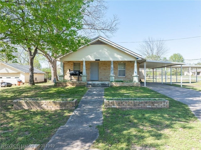 1120 Second St, Charleston, AR 72933 - view of front facade featuring brick siding, driveway, a carport, and a front lawn