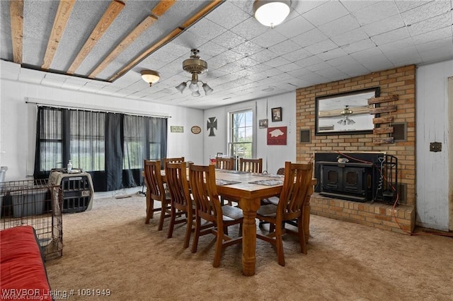 1120 Second St, Charleston, AR 72933 - dining space featuring carpet flooring and a wood stove