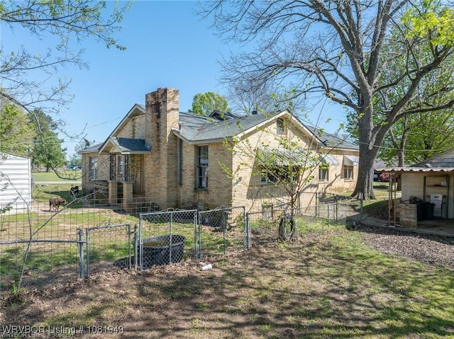 1120 Second St, Charleston, AR 72933 - back of property featuring a gate, a chimney, and brick siding