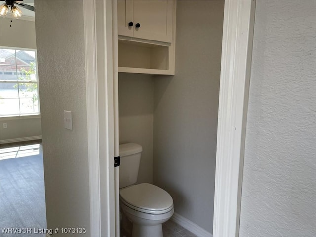 bathroom featuring ceiling fan and toilet