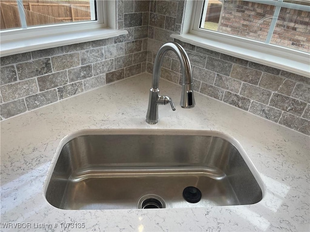 interior details with decorative backsplash and sink