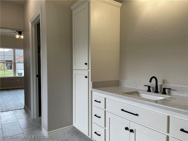 bathroom with tile patterned floors, ceiling fan, and vanity