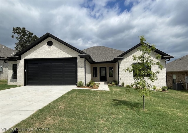 9109 Wayne Xing, Fort Smith, AR 72916 - view of front of home with central AC unit, a front yard, and a garage
