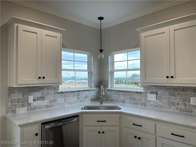 kitchen featuring stainless steel dishwasher, white cabinetry, sink, and tasteful backsplash