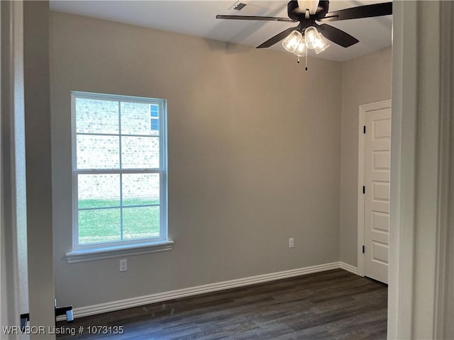 unfurnished room with ceiling fan, dark hardwood / wood-style floors, and a wealth of natural light