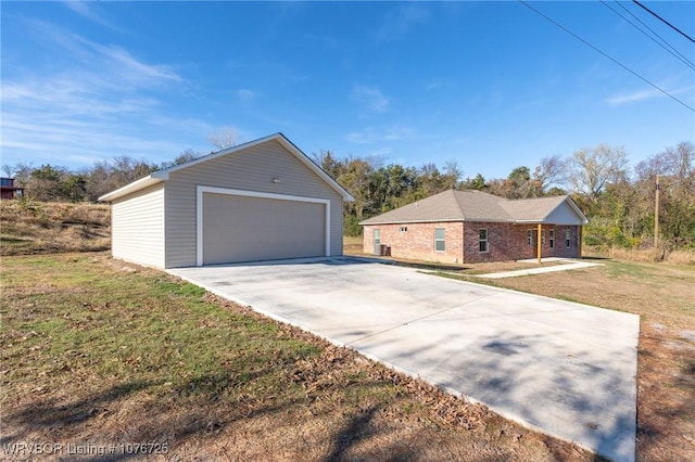 view of home's exterior featuring a garage, a yard, and an outbuilding