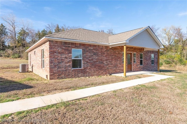 ranch-style house with a front lawn, a patio, and central AC