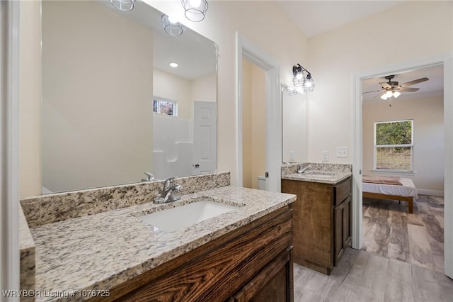 bathroom with hardwood / wood-style floors, vanity, and ceiling fan