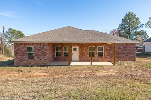 back of house featuring a patio and a lawn