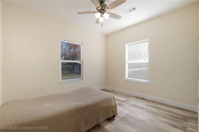 unfurnished bedroom with ceiling fan and light hardwood / wood-style floors